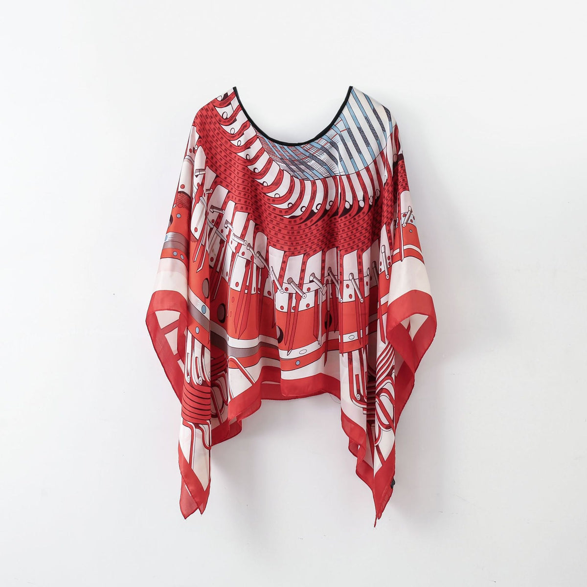 Red-and-white graphic poncho-style pullover shawl scarf with black neckline