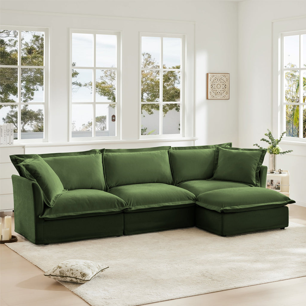 Green slipcovered L-shaped sectional sofa with deep chaise and multiple back cushions
