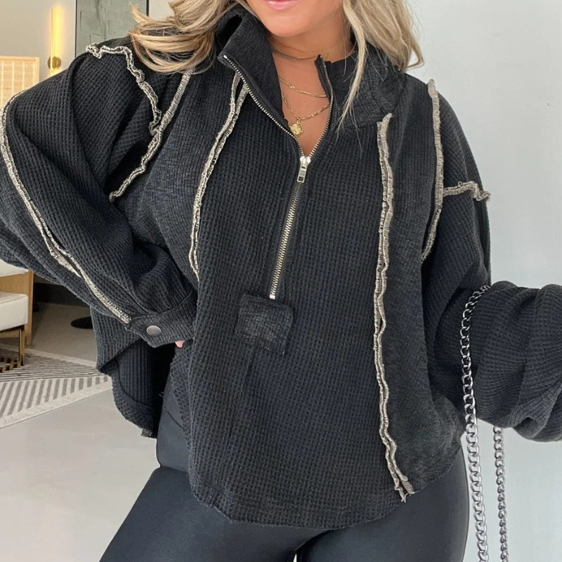 Black quarter-zip sweater with contrast rope trim and frayed hood seams