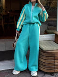 Teal contrast-striped zip-up top and wide-leg pants set with side stripe detailing.