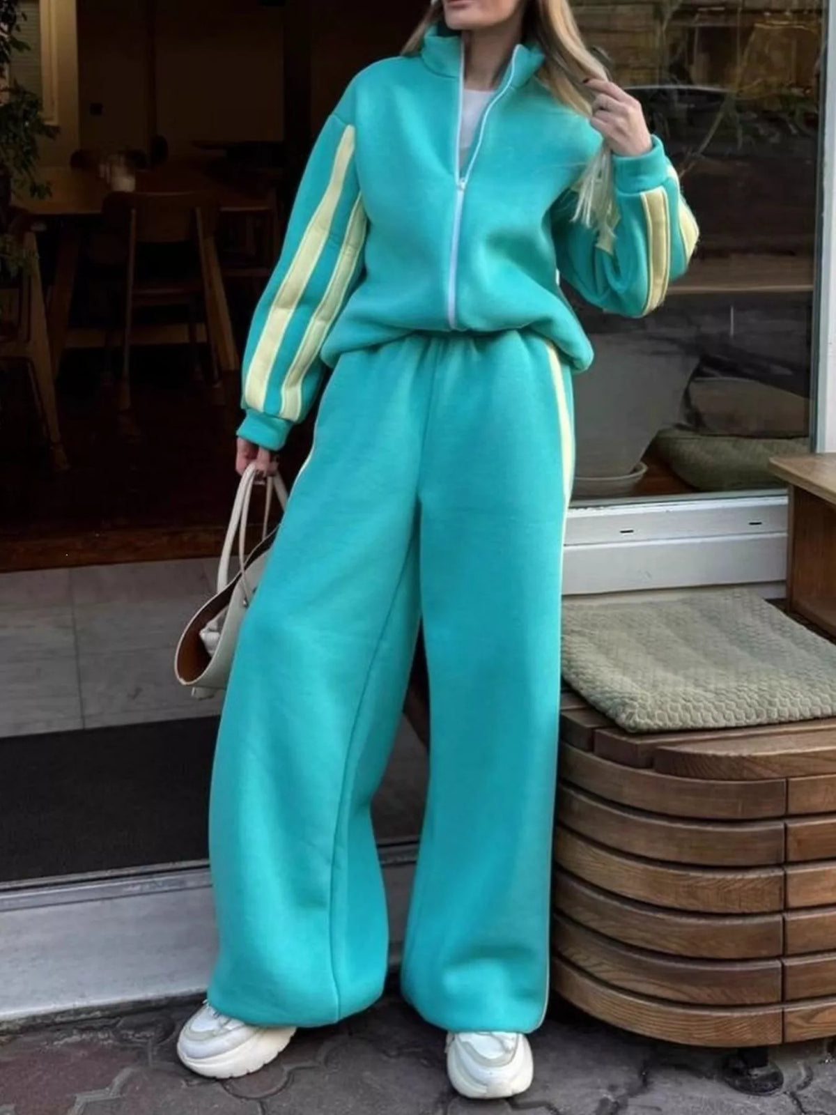 Teal contrast-striped zip-up top and wide-leg pants set with side stripe detailing.
