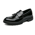 Black leather tassel loafers with wide strap and thick rubber sole