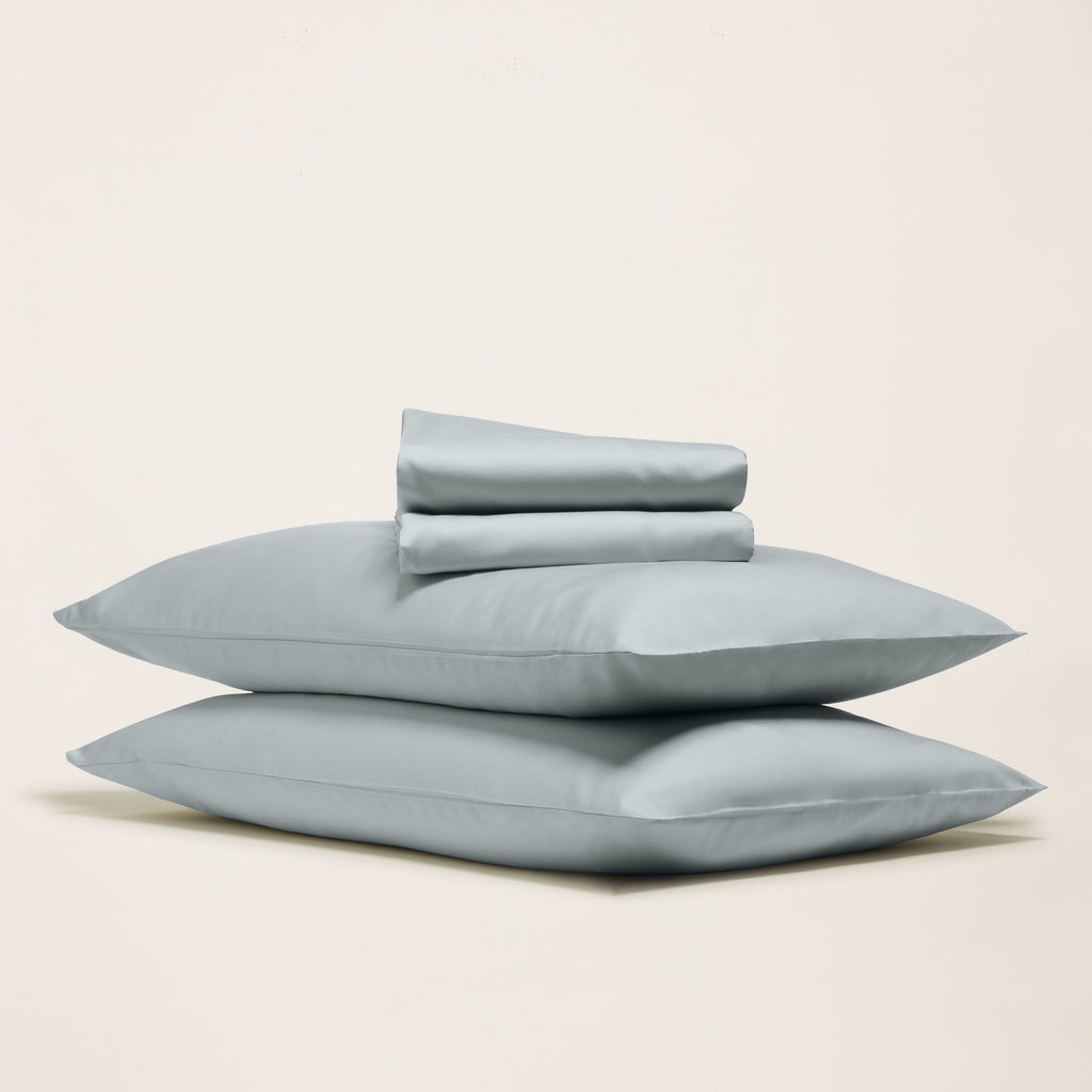 Pale blue sateen bedding bundle with stacked sheets and matching pillowcases