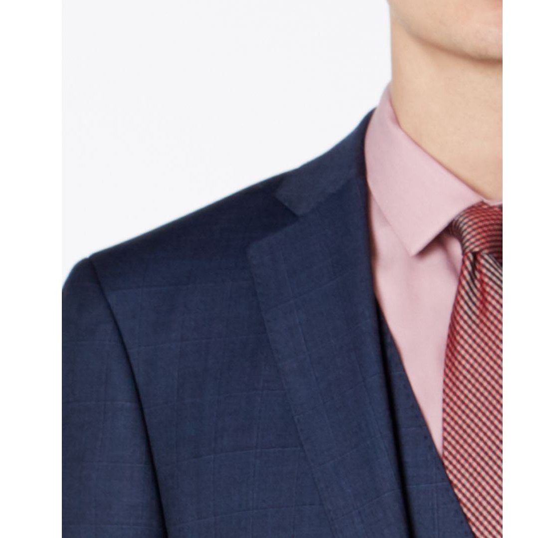 Blue suit jacket lapel close-up with tonal windowpane weave and pink striped tie