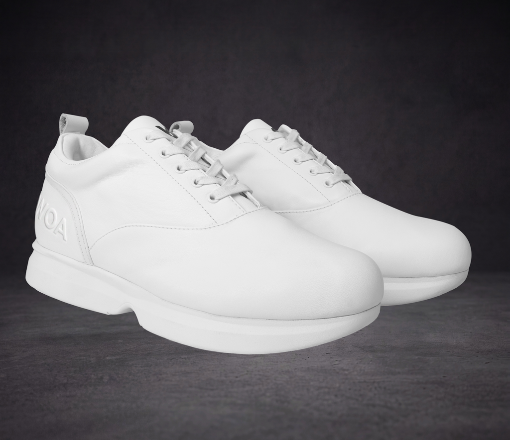White lace-up sneakers with smooth toe box and WOA logo on heel counter