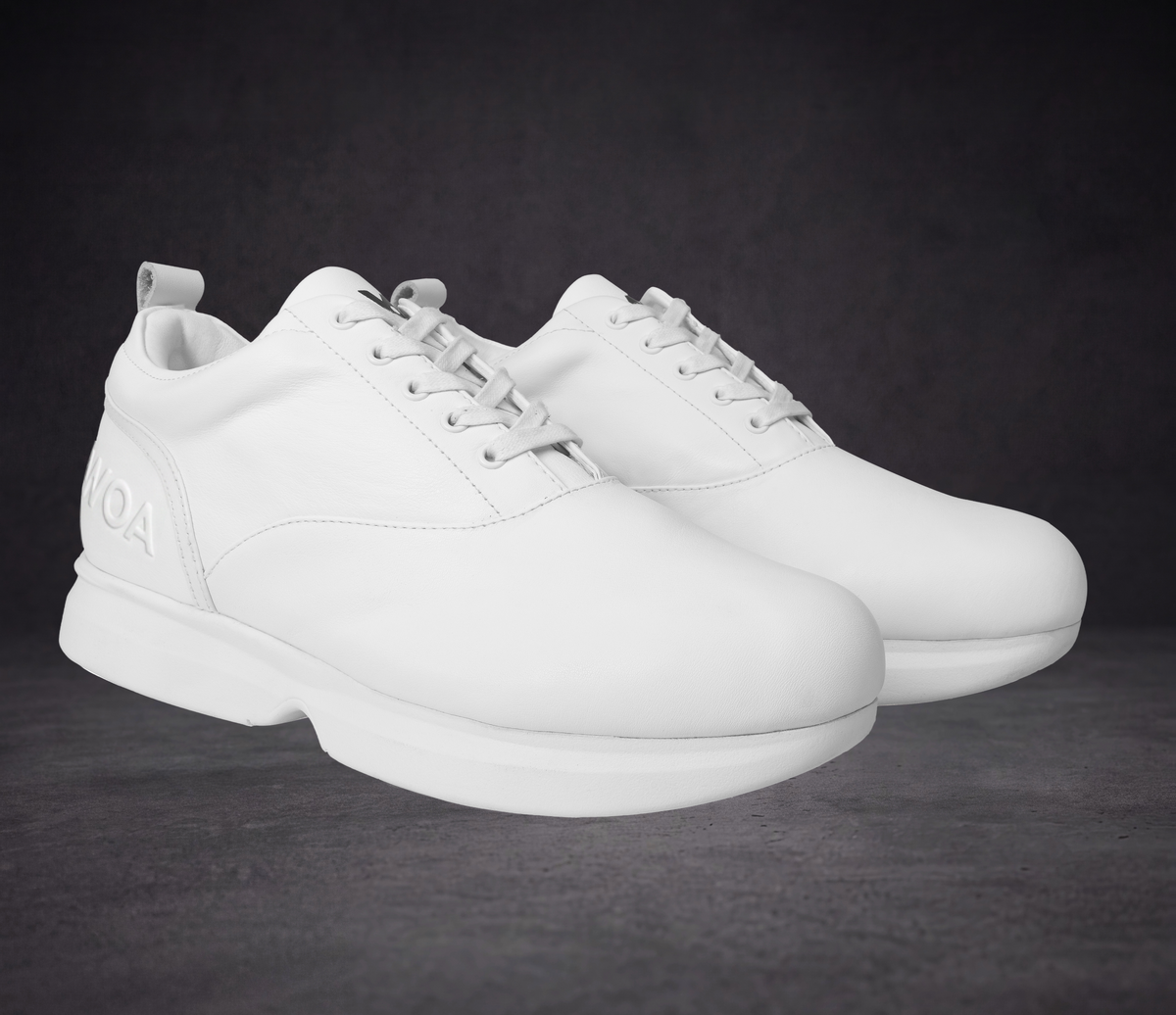White lace-up sneakers with smooth toe box and WOA logo on heel counter