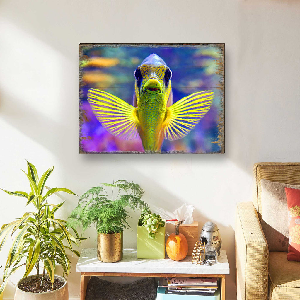 Framed tropical fish wall art with winged fish face, colorful ocean-style artwork.