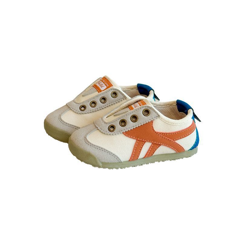 Kids casual sneakers with white uppers, orange side stripes, and blue heel accents.