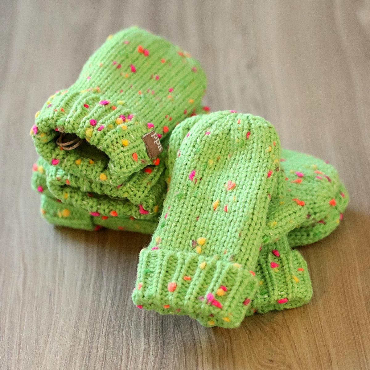 Lime green speckled knit mittens with ribbed cuffs, soft fleece lining