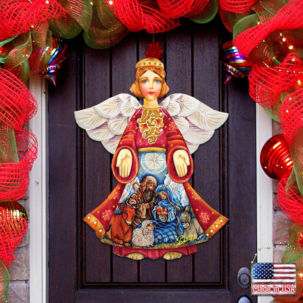 Nativity angel door decor with white wings; red robe holds rings over small nativity scene