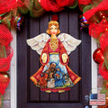 Nativity angel door decor with white wings; red robe holds rings over small nativity scene