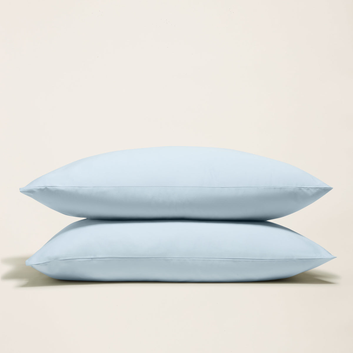 Light blue pillowcases with a smooth sateen finish, stacked for display