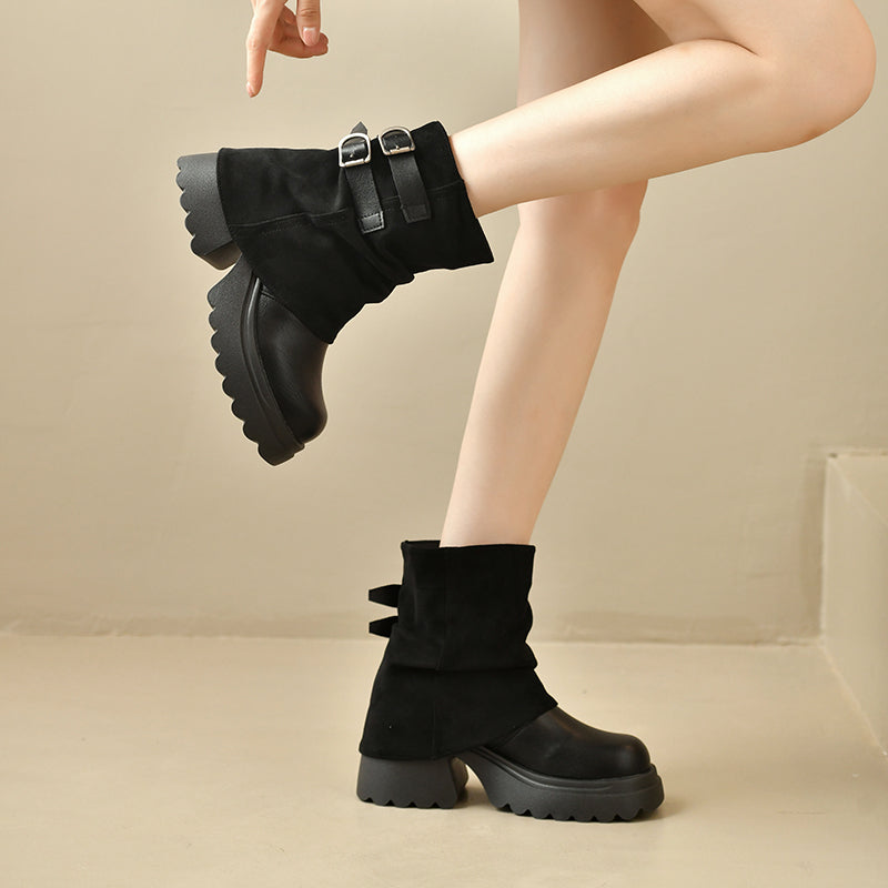 Black slouchy platform combat ankle boots with buckled straps and chunky tread sole.