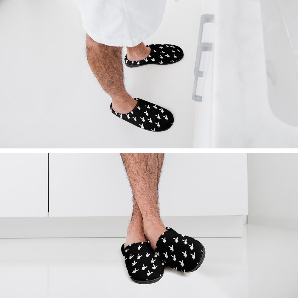 Black cotton slippers with white bunny pattern worn by a person, slip-on style