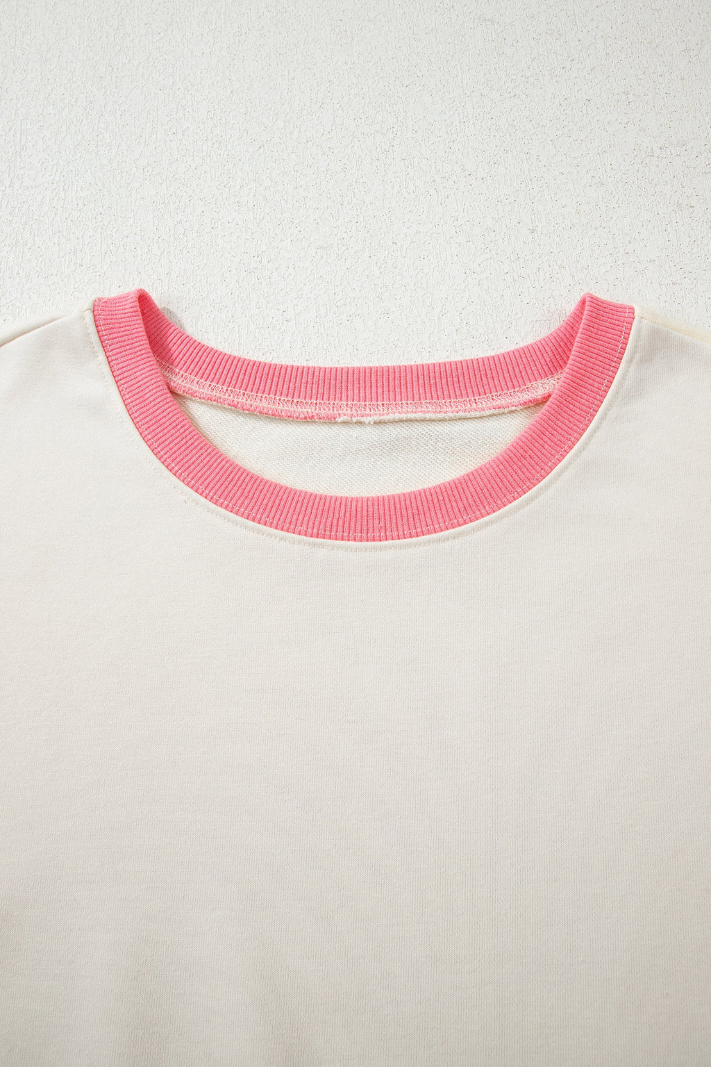 Cream sweatshirt neckline with pink crew ribbed trim