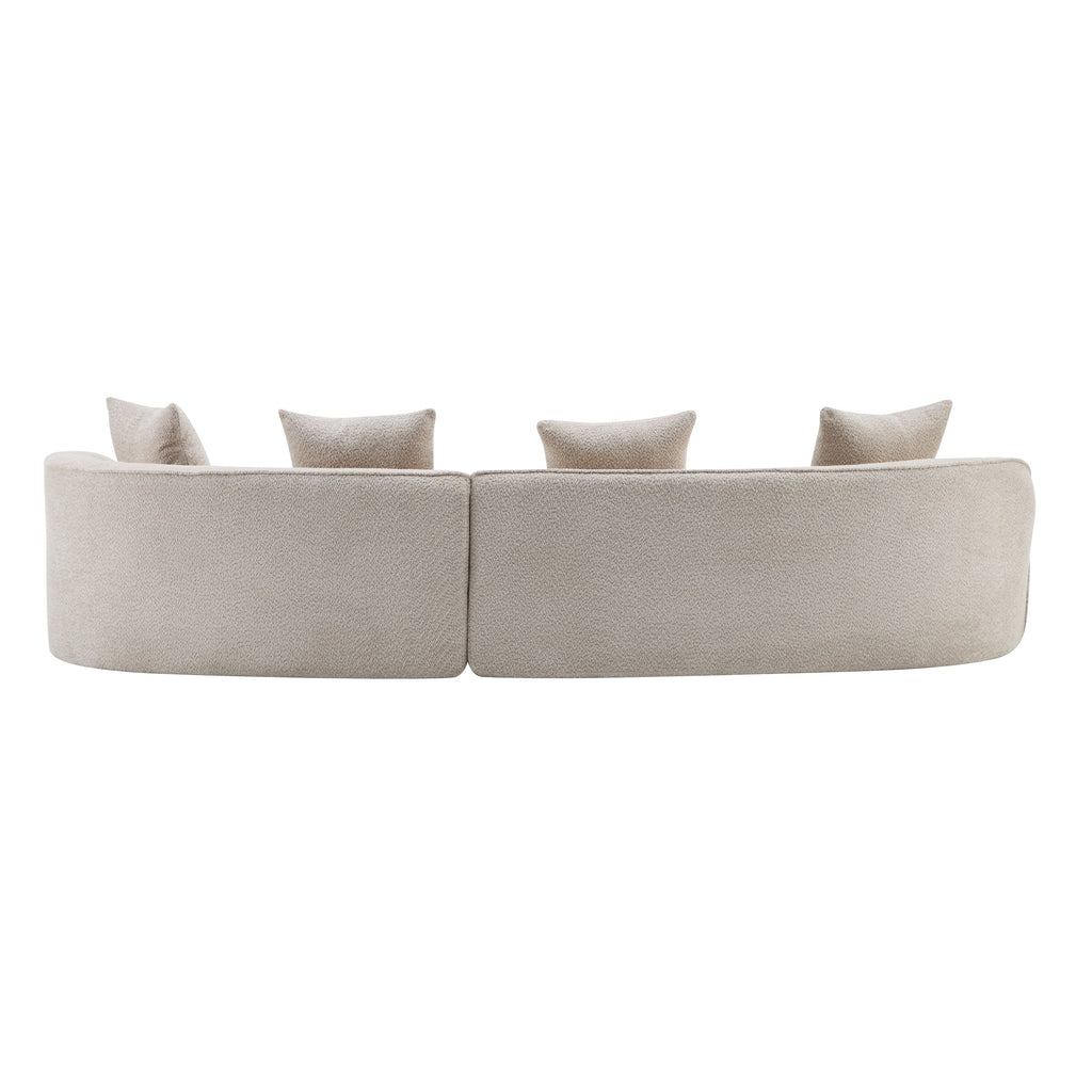 Light beige curved sectional sofa with central seam and four throw pillows