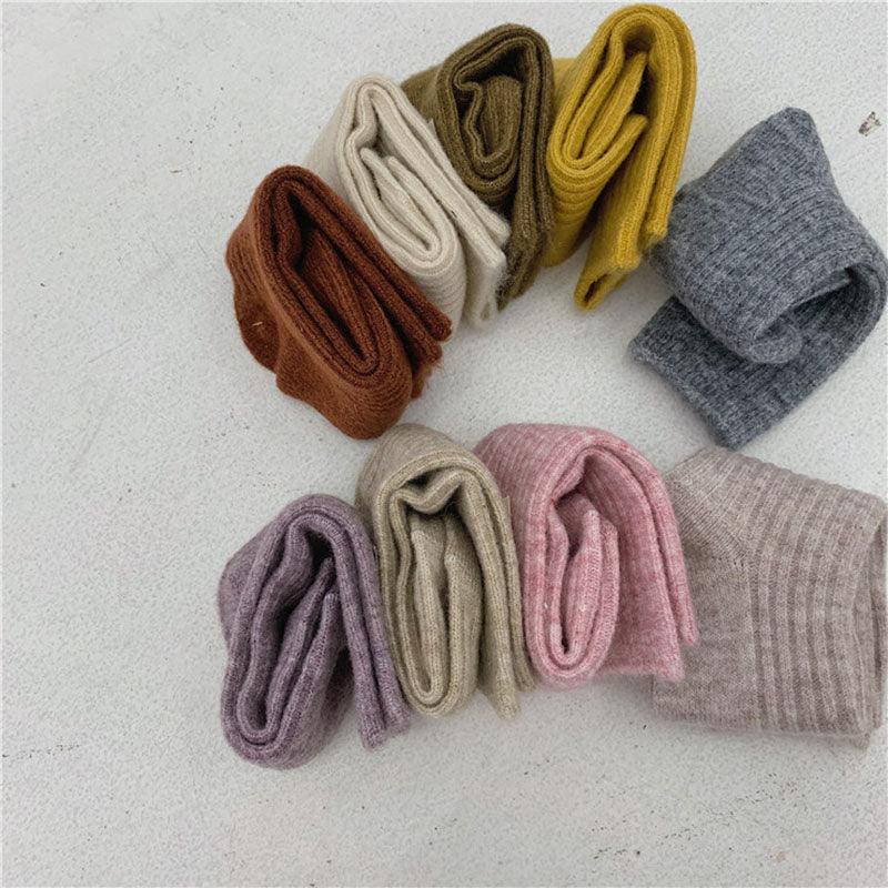 Mid-calf thick cotton pile socks, six solid colors shown as rolled pairs