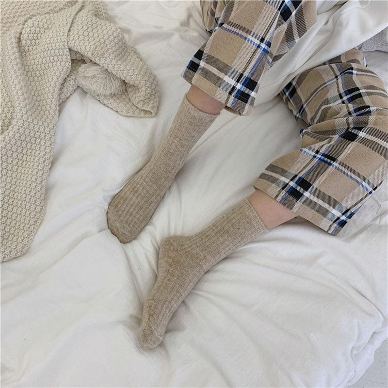 Mid-tube socks in light beige, ribbed knit worn on feet