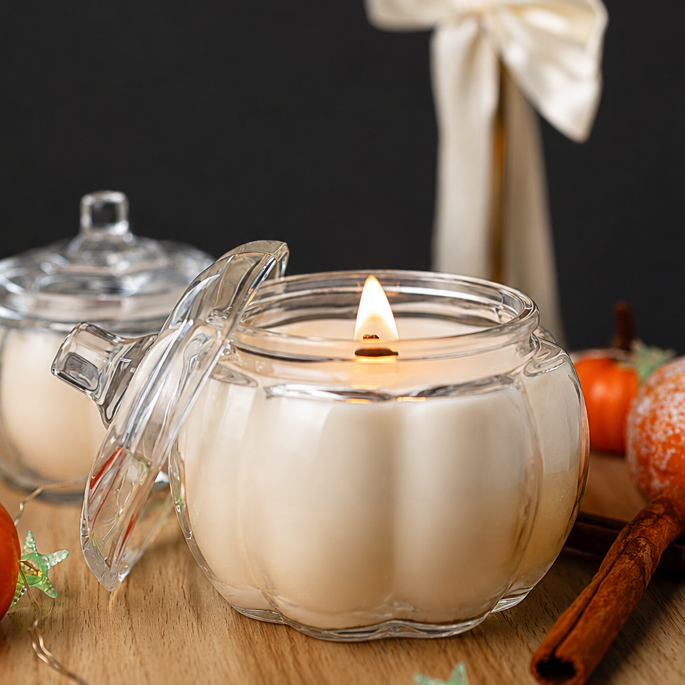 Clear glass candle jar with cream wax and lid, burning wick visible