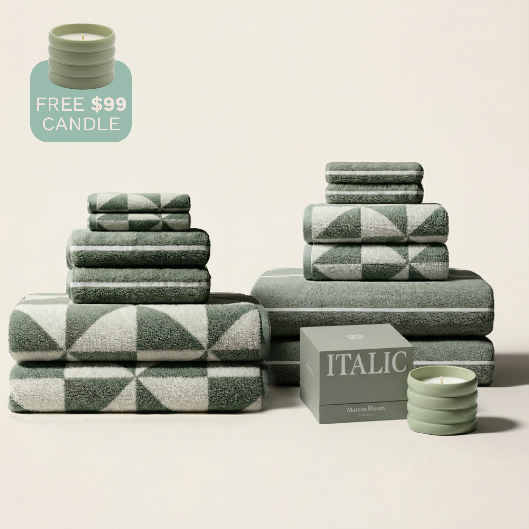 Stacked sage and ecru geometric cotton towels, folded into multiple sets