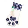 Blue plaid pet paw hanging Christmas stocking with white background and paw-print patch