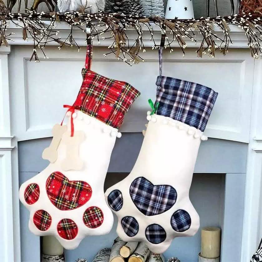 Pet paw hanging Christmas stockings in red and blue plaid with white paw-print design