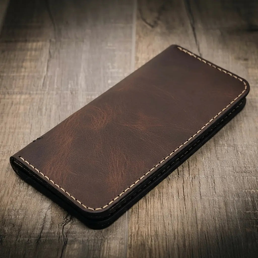 Brown long leather wallet with smooth front, stitched edge, rounded corners.