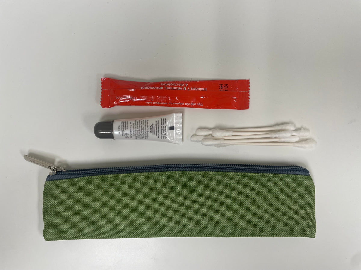 Green fabric pencil pouch with zip top, with small accessories and cable above.