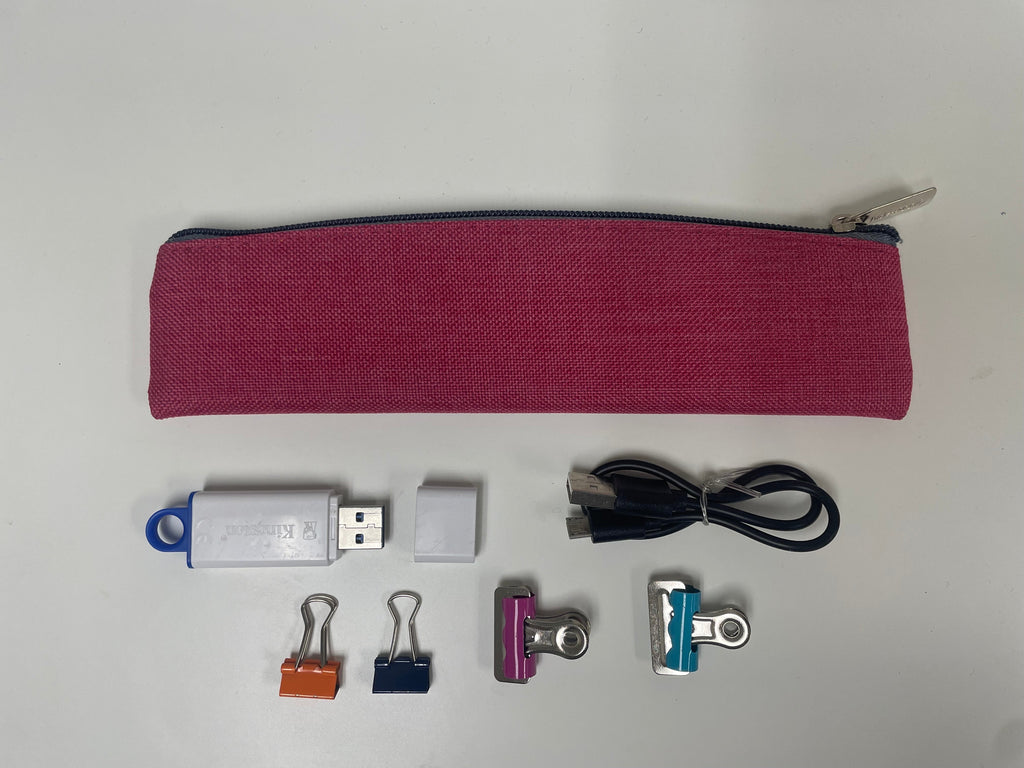 Pink fabric pencil pouch with zip top, with USB cable and accessories below.