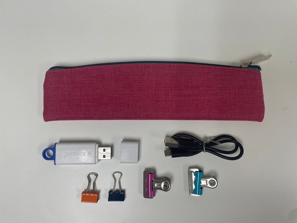 Pink fabric pencil pouch with zip top, with USB cable and accessories below.