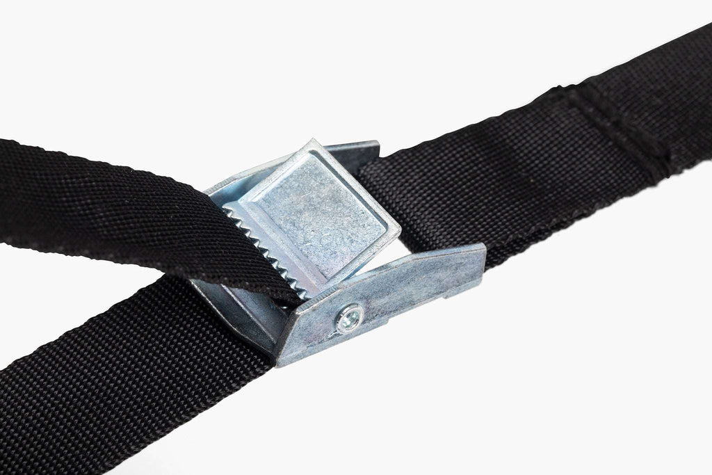 Black strap with metal buckle for securing a lawn roller