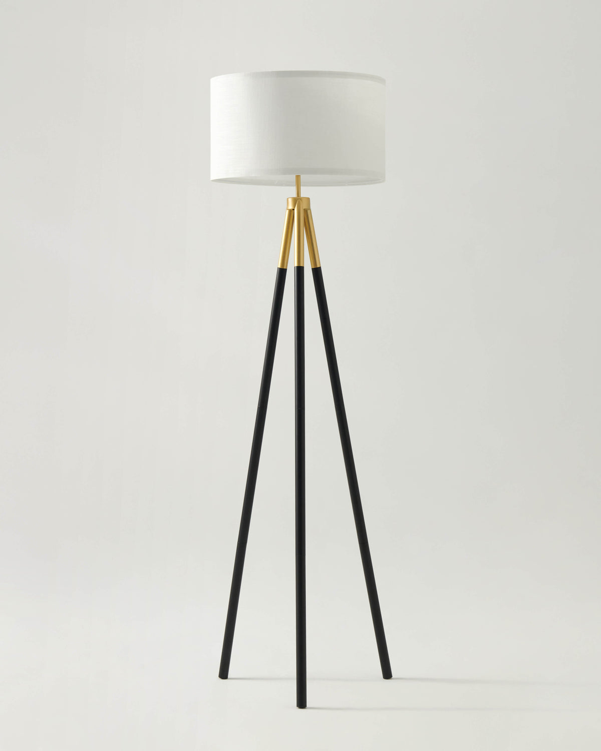 Levi floor lamp with white fabric shade and black tripod legs