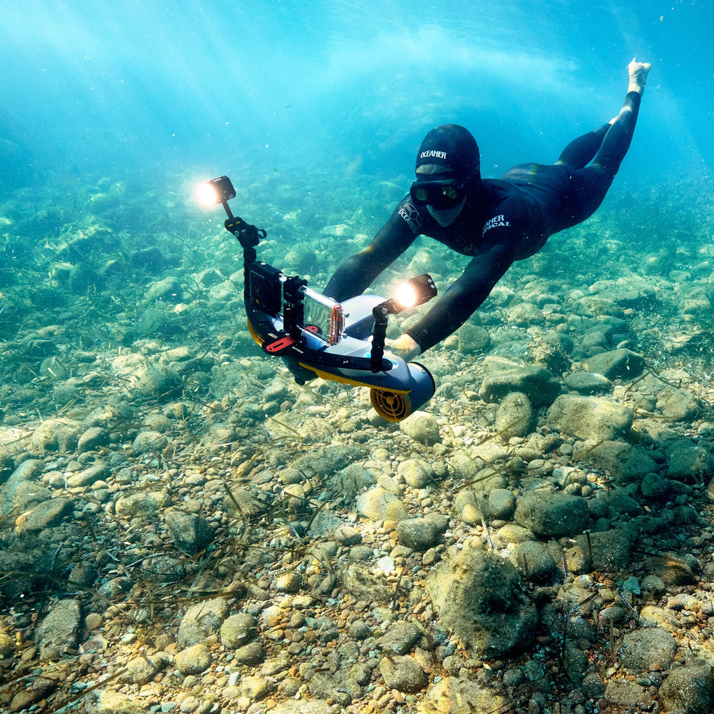 Clear waterproof phone case on diver rig, black mounts and orange control pod