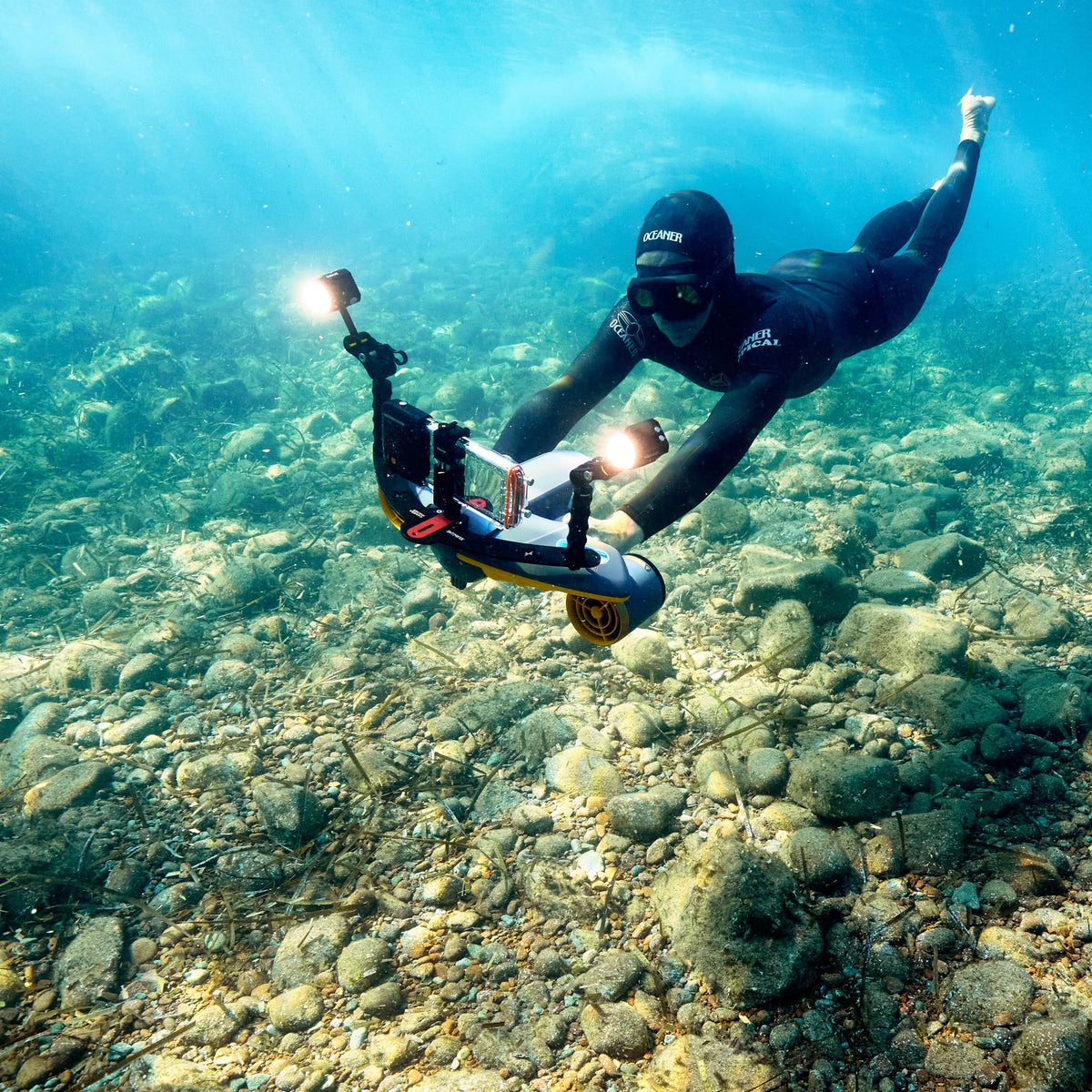 Clear waterproof phone case on diver rig, black mounts and orange control pod