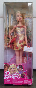 Barbie Holiday Barbie fashion doll in festive pink and gold dress, in box