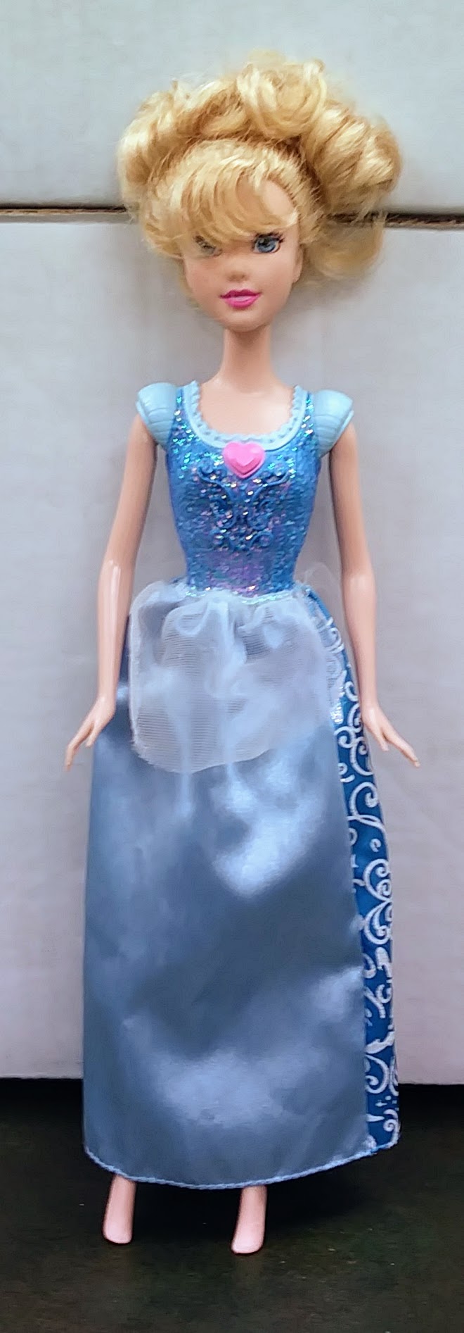 Loose princess doll with blonde updo, blue sparkling bodice and satin skirt dress