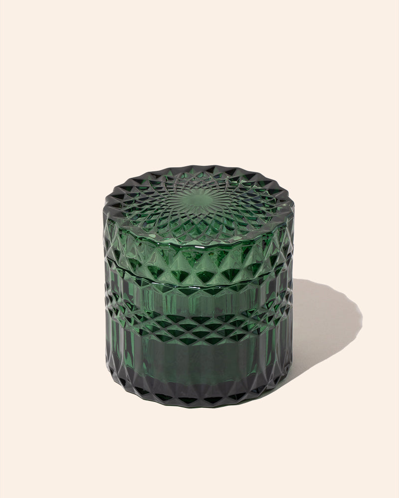 Faceted candle vessel with lid, translucent emerald green