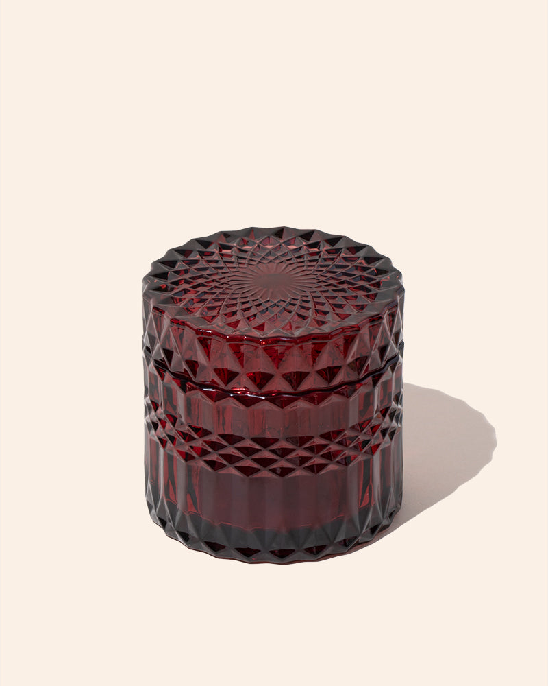 Faceted candle vessel with lid, translucent burgundy red