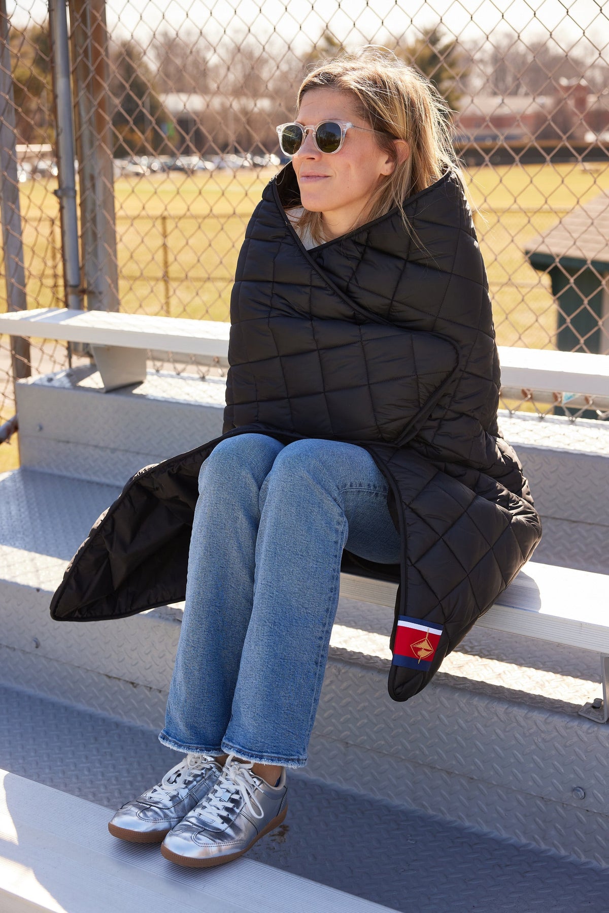 Black quilted puffer blanket with side pocket detail
