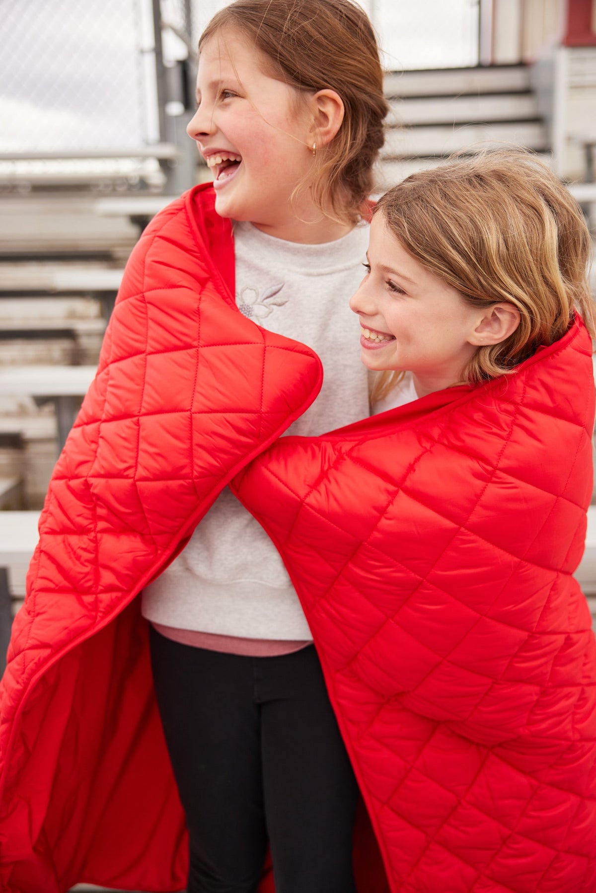 Red quilted waterproof puffer blanket with stitched diamond pattern
