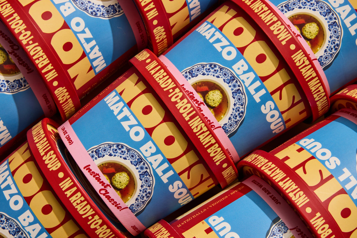 Pack of instant soup cups stacked together with red rims and blue matzo ball graphics