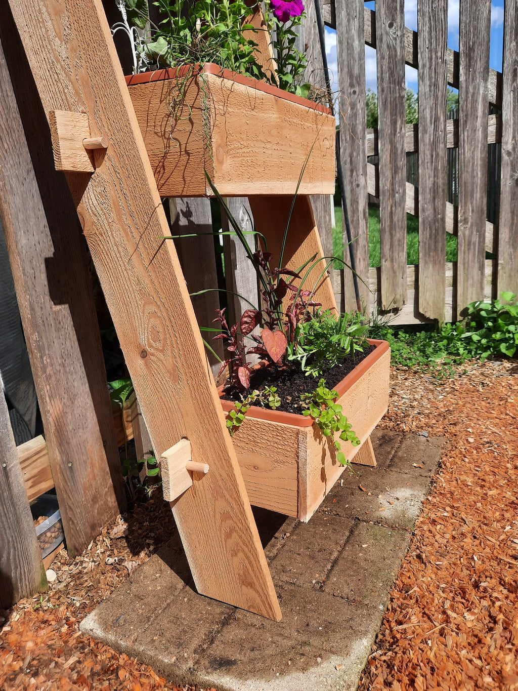 3-tier vertical cedar standing planter box with three wooden troughs on a standing frame