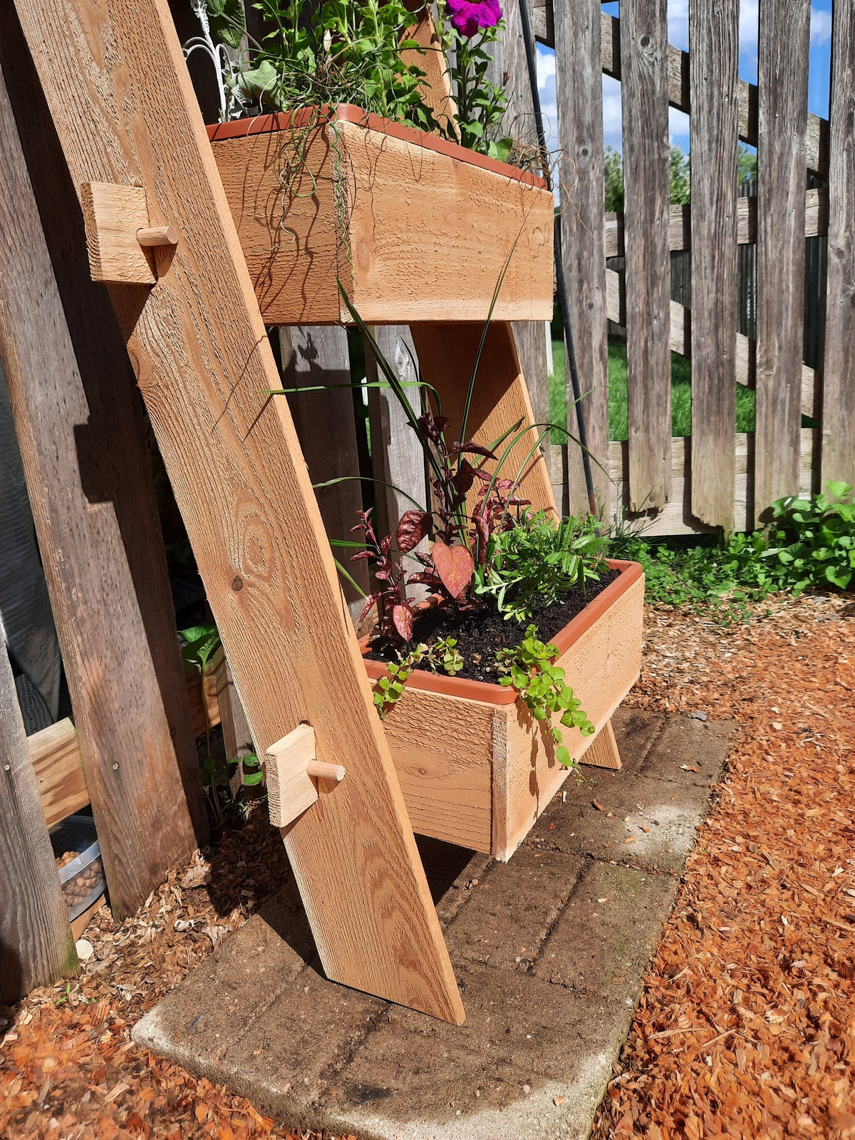 3-tier vertical cedar standing planter box with three wooden troughs on a standing frame