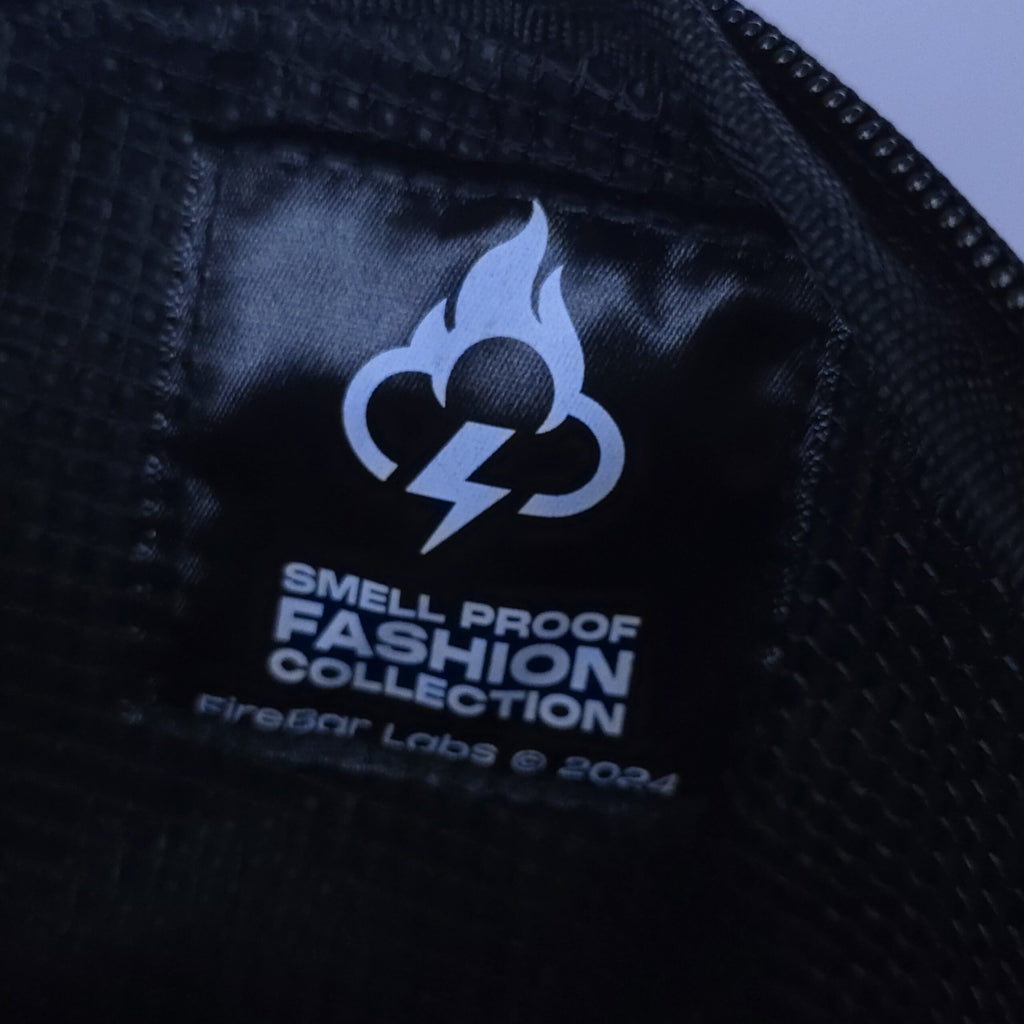 Smell proof crossbody bag inner panel with FireBar Labs logo and fashion message text