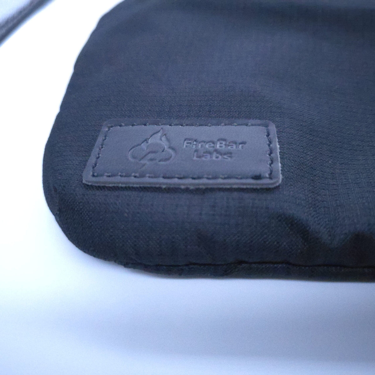 Smell proof crossbody bag corner with FireBar Labs fabric logo patch