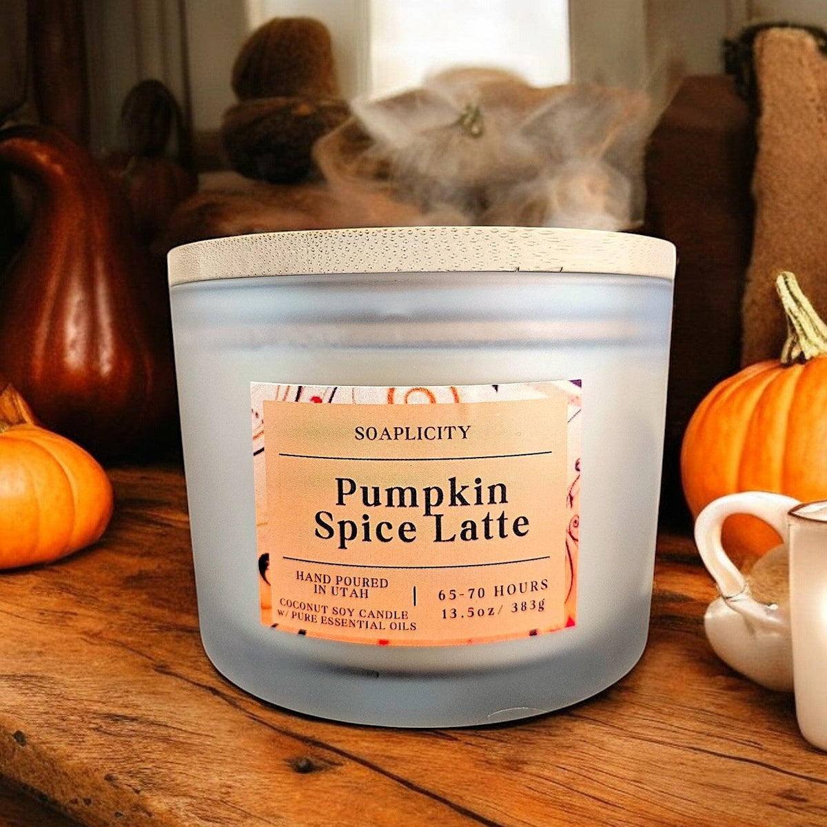 Coconut-soy pumpkin spice latte candle in frosted gray jar with paper label, lid on