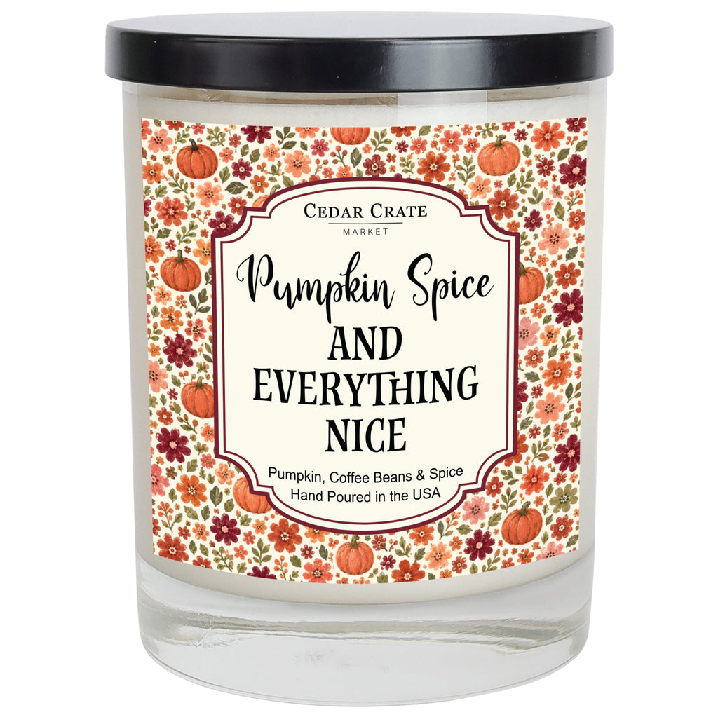 Pumpkin spice scented candle jar with floral label, black lid, and clear glass base.