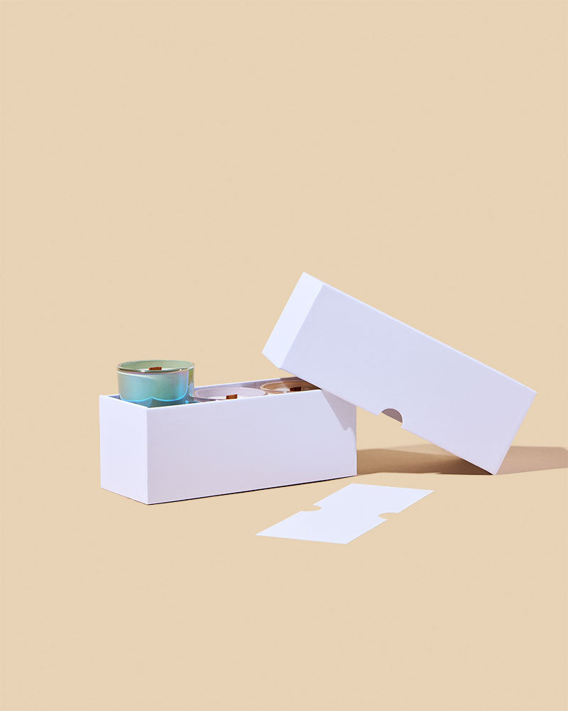White linen candle box open with three candles and angled lid