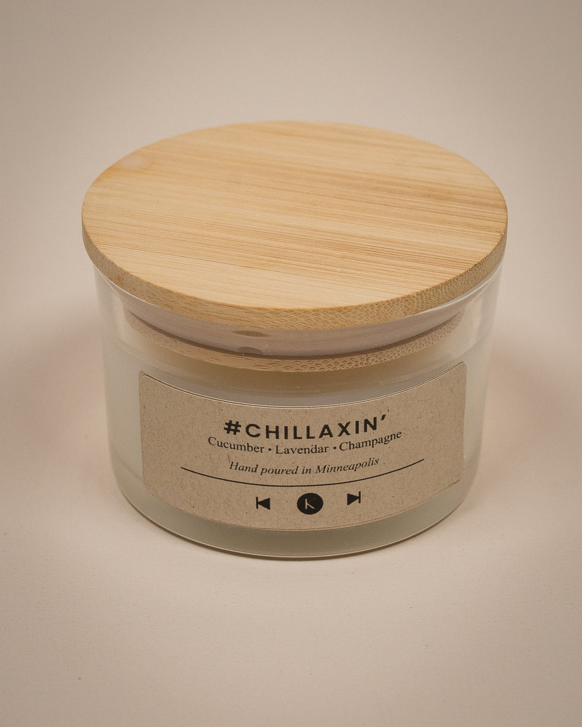 Luxury candle jar with clear sides, cream wax, wooden lid, printed scent label