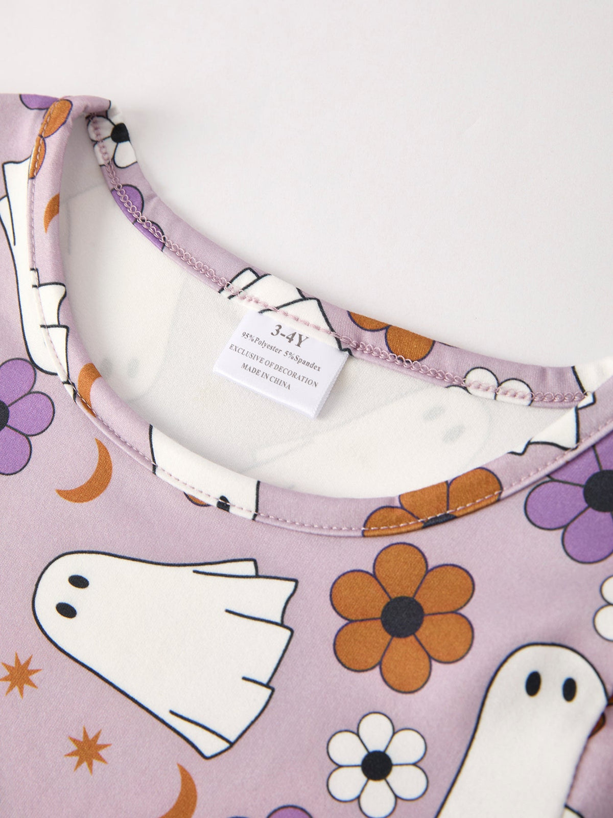 Girls' ghost print Halloween dress neckline yoke with purple floral trim and tag